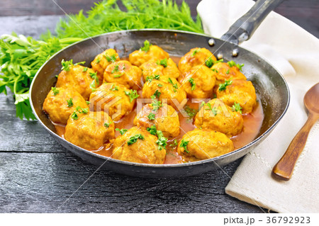 Meatballs in pan with greens on board Meatballs in pan with greens on board 36792923