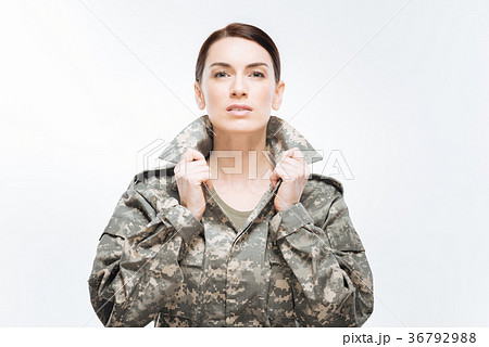 Young earnest woman placing her collar 36792988