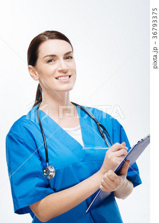 Cheerful female physician writing down family 36793375