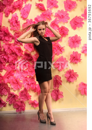 Beautiful girl with long hair at flowers background 36793692