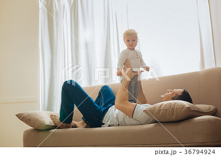 Adorable baby standing on the fathers tummy and 36794924