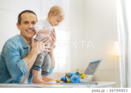 Happy parent helping his amazing baby to stand on Happy parent helping his amazing baby to stand on 36794953
