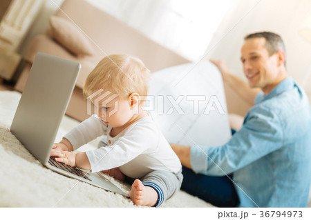 Busy baby having fun with a laptop while trying to 36794973