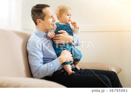 Positive young father watching a nice film while 36795061