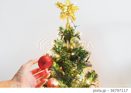 Hand decorating Christmas tree 36797117