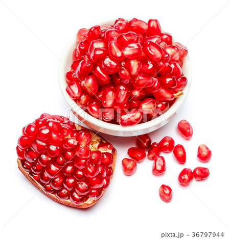 Pomegranate and seeds in ceramic bowl close-up Pomegranate and seeds in ceramic bowl close-up 36797944