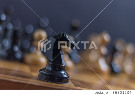 Chess horse staying in front of chess pieces 36801234