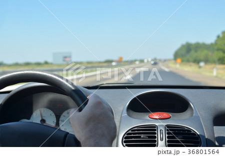Man driving on a highway Man driving on a highway 36801564