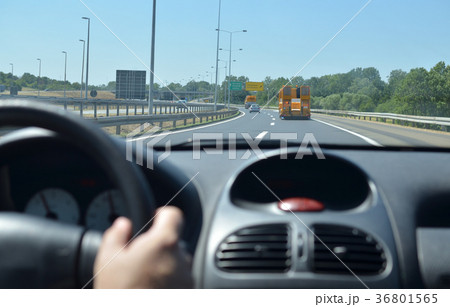 Man driving a car on a motorway Man driving a car on a motorway 36801565