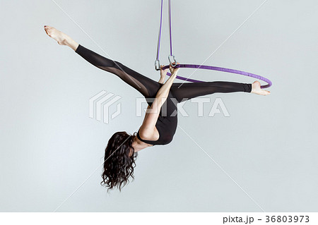 Woman aerial acrobat on the ring. Woman aerial acrobat on the ring. 36803973