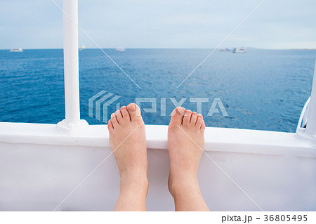 legs against the backdrop of a yacht and azure sea 36805495