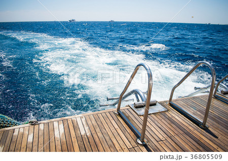 stern of a yacht with boarding ladder against sea stern of a yacht with boarding ladder against sea 36805509