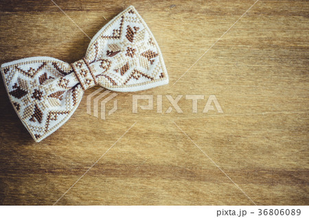 Embroidered Bow Tie on Wooden Brown Background. 36806089