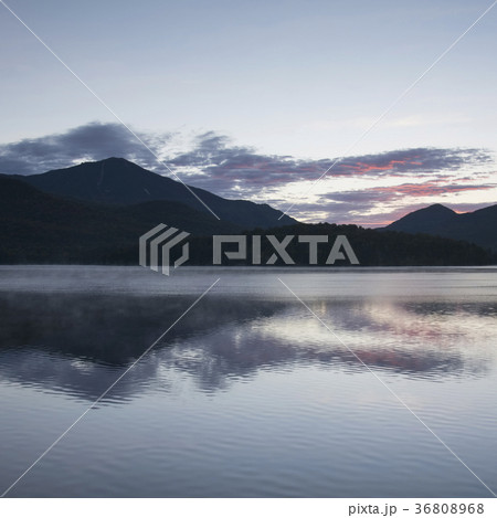 USA, New York, Lake Placid, Mountain and clouds reflecting in lake 36808968