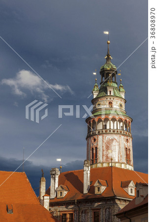 Czech Republic, South Bohemia, Cesky Krumlov, Castle tower against storm clouds 36808970