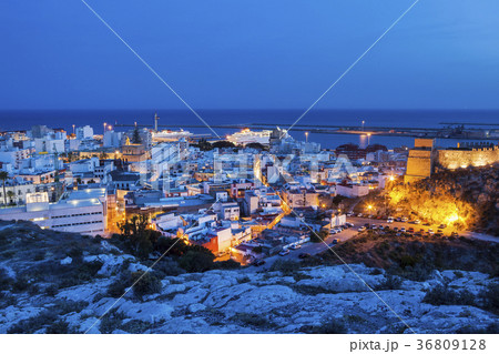 Spain, Andalusia, Almeria, Cityscape with sea at dusk 36809128