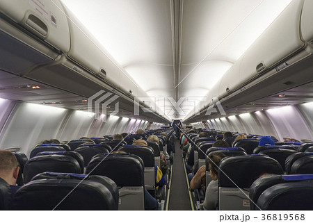 Interior of airplane with passengers on seats. Interior of airplane with passengers on seats. 36819568