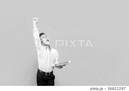 Happy young boy using a tablet. Studio shot Happy young boy using a tablet. Studio shot 36822287