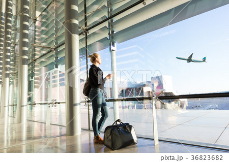 Young woman waiting at airport, looking through Young woman waiting at airport, looking through 36823682