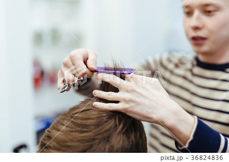 hairdresser in the beauty salon does a haircut hairdresser in the beauty salon does a haircut 36824836