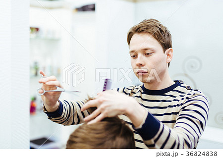 hairdresser in the beauty salon does a haircut hairdresser in the beauty salon does a haircut 36824838