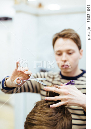 hairdresser in the beauty salon does a haircut hairdresser in the beauty salon does a haircut 36824841