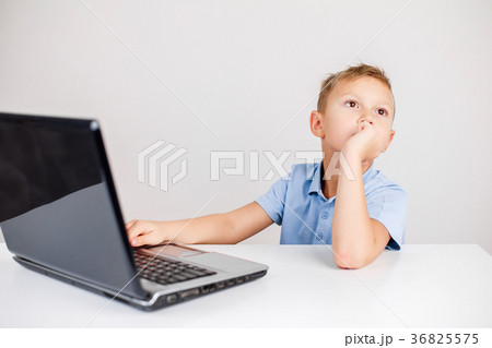 Pensive kid at laptop Pensive kid at laptop 36825575