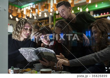 Group of teenagers doing homework in cafe. 36826899
