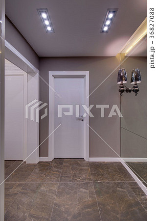 Corridor with white doors, a dark floor and a big Corridor with white doors, a dark floor and a big 36827088