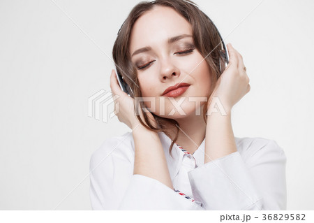 Happy Girl Listen Music in White Headphones and 36829582