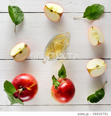 Fresh apples and vinegar on wooden table  36830791