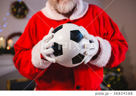 Santa claus holding a football Santa claus holding a football 36834588