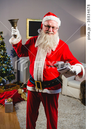 Santa claus ringing a bell at home 36834678