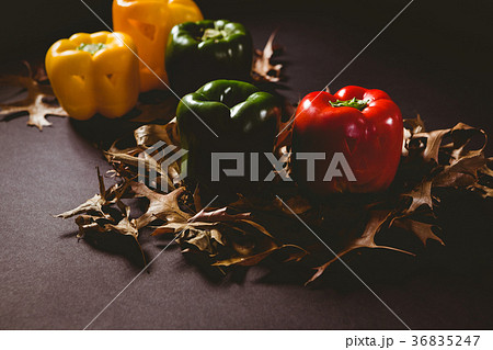 Carved bell pepper with autumn leaves on wooden table 36835247