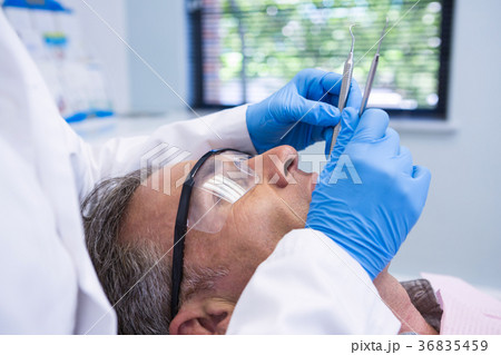 Doctor giving dental treatment to patient Doctor giving dental treatment to patient 36835459