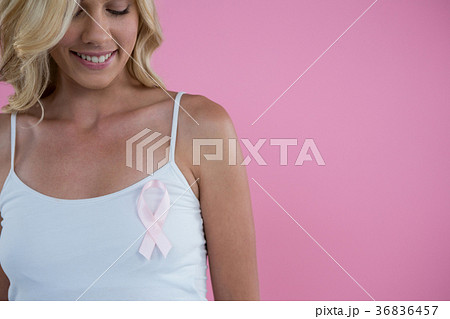 Smiling woman with Breast Cancer Awareness ribbon Smiling woman with Breast Cancer Awareness ribbon 36836457