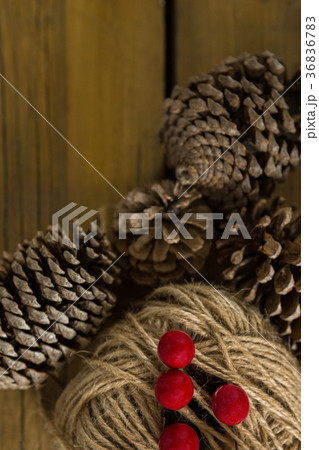 Directly above shot of pine cones with thread spool with push pin 36836783