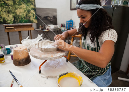 Happy woman molding clay Happy woman molding clay 36836787