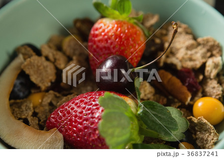 Bowl of breakfast cereals with fruits on black background Bowl of breakfast cereals with fruits on black background 36837241