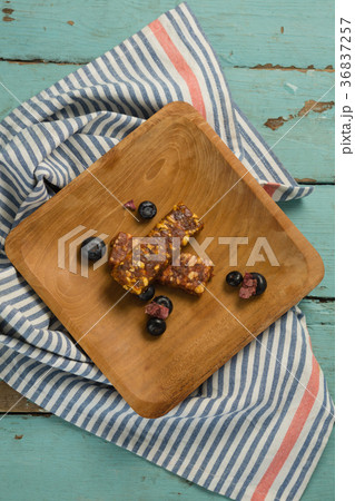 Granola bar and blueberry on wooden plate 36837257