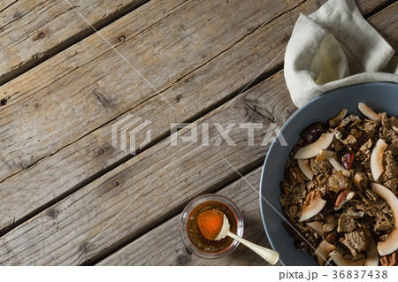 Healthy breakfast in bowl and honey on a wooden table 36837438