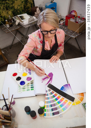 Woman painting in drawing book 36837439