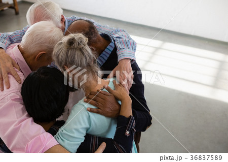 High angle view of senior male and female friends huddling High angle view of senior male and female friends huddling 36837589