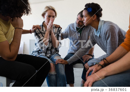 Friends consoling worried woman 36837601