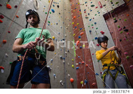 Low angle view of athletes tying rope in health club Low angle view of athletes tying rope in health club 36837874
