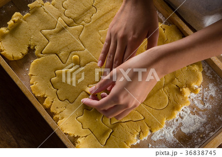 Man removing gingerbread dough on wooden table Man removing gingerbread dough on wooden table 36838745