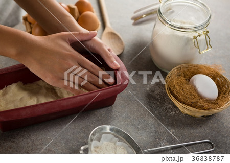 Woman preparing dough surrounded with various ingredients 36838787