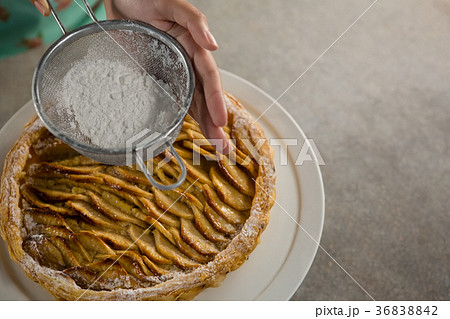 Woman icing on apple tart Woman icing on apple tart 36838842