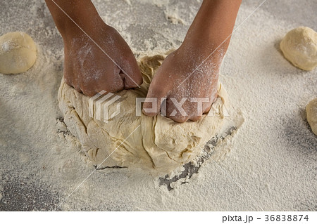 Woman kneading a dough 36838874
