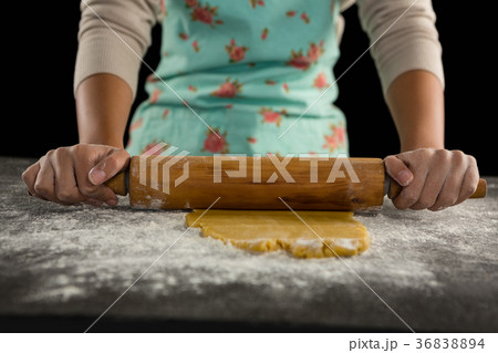 Woman baking dough with rolling pin 36838894